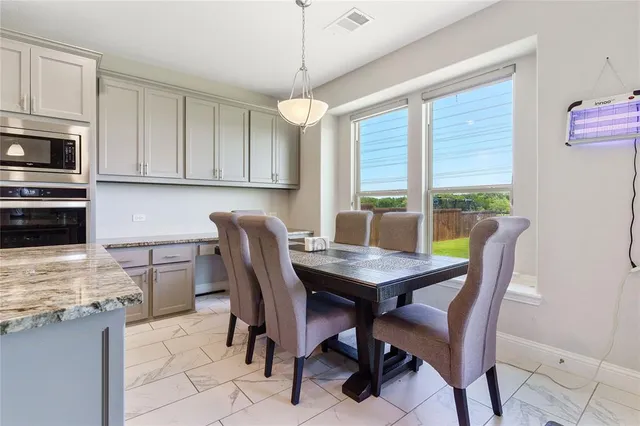 a kitchen with stainless steel appliances granite countertop a stove microwave and refrigerator