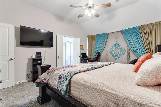 a bedroom with a bed and a dresser in it