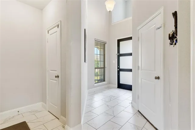 a view of a hallway with wooden floor and entryway