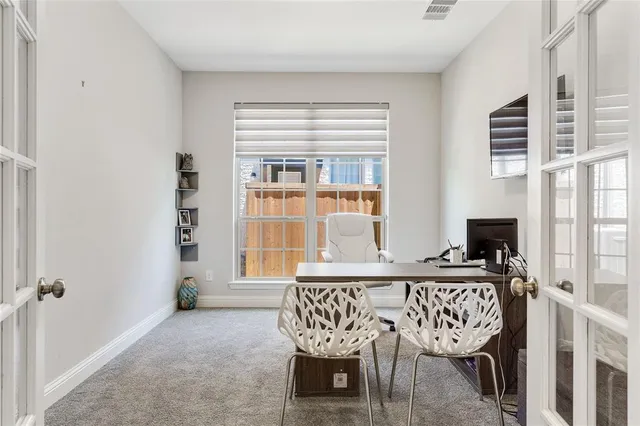 a work room with furniture and a flat screen tv