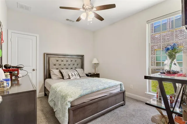 a bedroom with a large bed and a flat screen tv