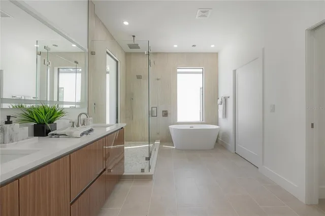 a white bath tub sitting next to a bathroom