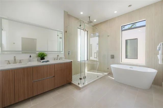 a bathroom with a sink mirror and a bath tub