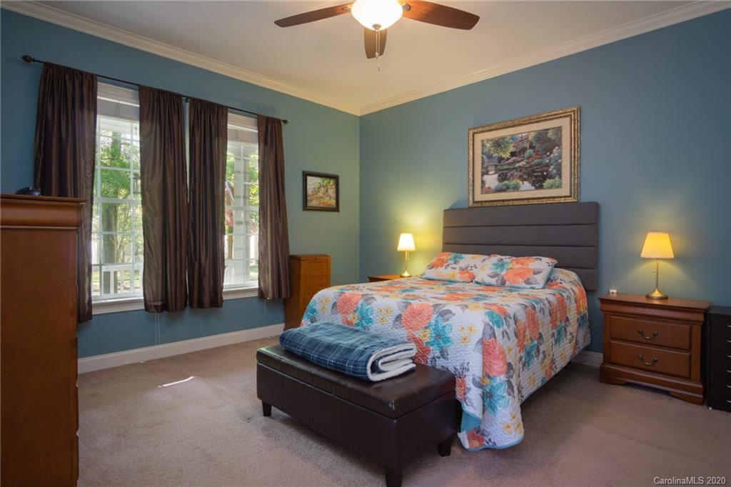 3236 Colonel Springs Way Fort Mill, SC 29708 - Photo 22 of 45 a bedroom with a bed and a chandelier