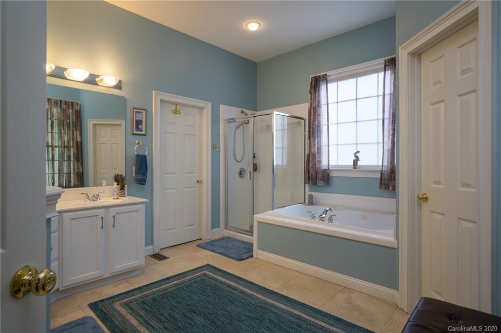3236 Colonel Springs Way Fort Mill, SC 29708 - Photo 24 of 45 a bathroom with a tub sink and mirror