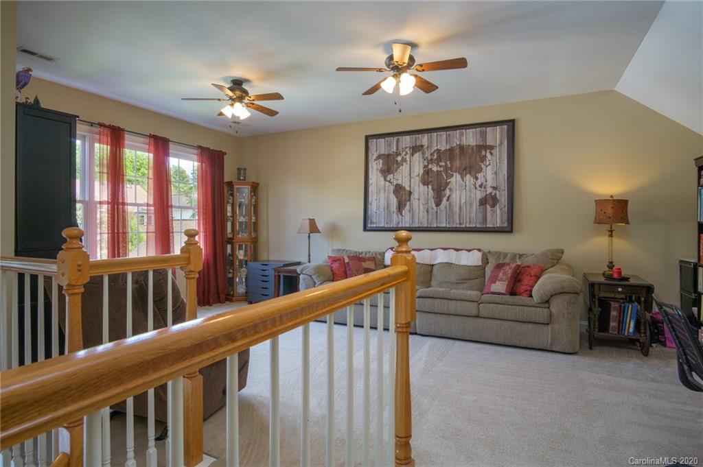 3236 Colonel Springs Way Fort Mill, SC 29708 - Photo 28 of 45 a living room with furniture and a chandelier