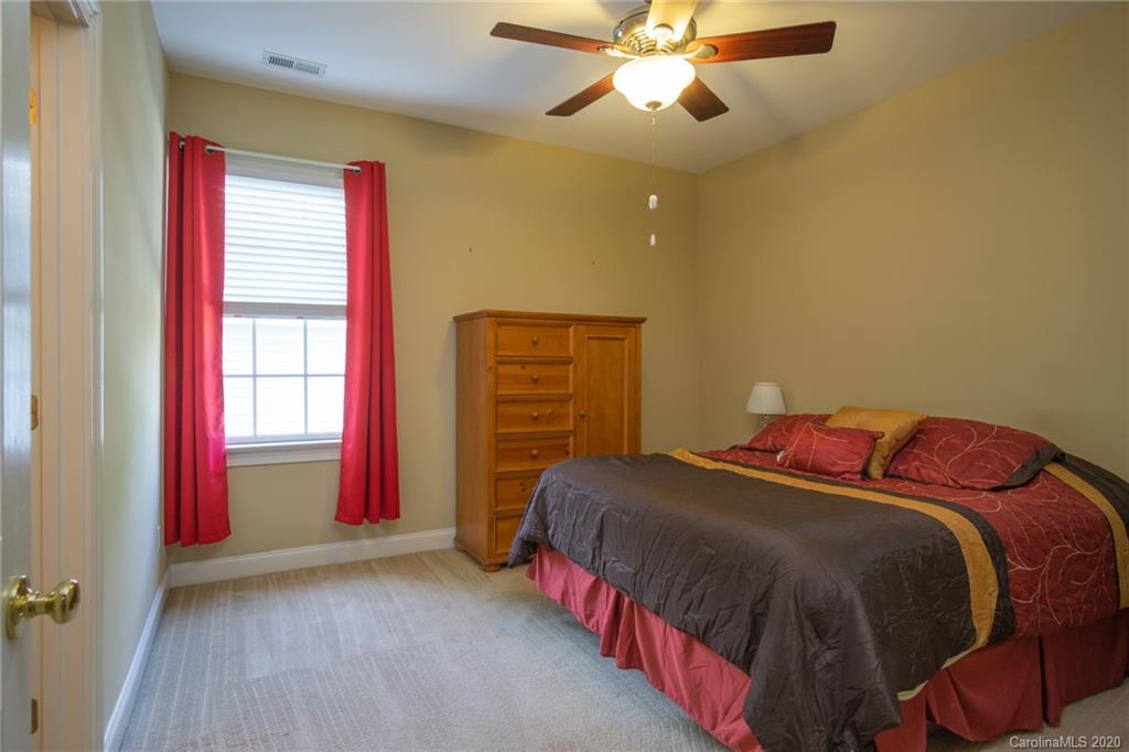 3236 Colonel Springs Way Fort Mill, SC 29708 - Photo 33 of 45 a bedroom with a bed and a chandelier