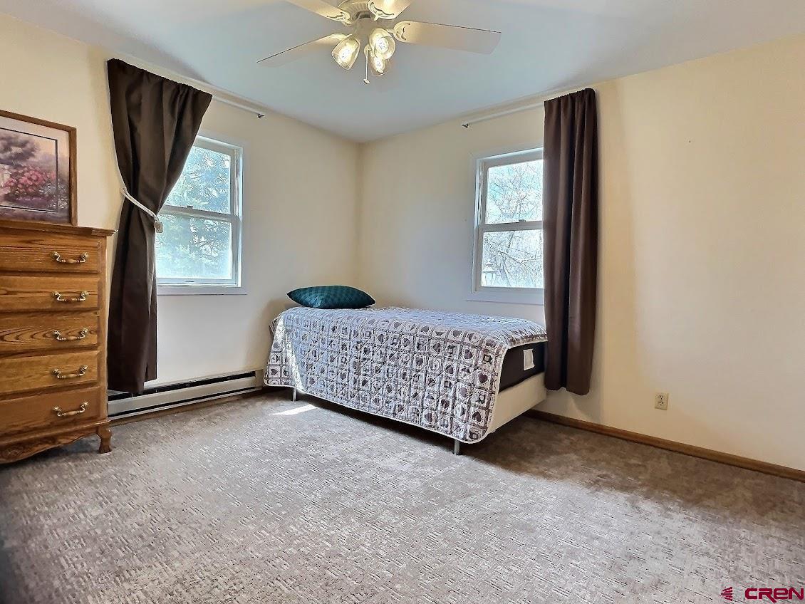 21007 Marion Road Eckert, CO 81418 - Photo 20 of 35 a bedroom with a bed and a painting on the wall