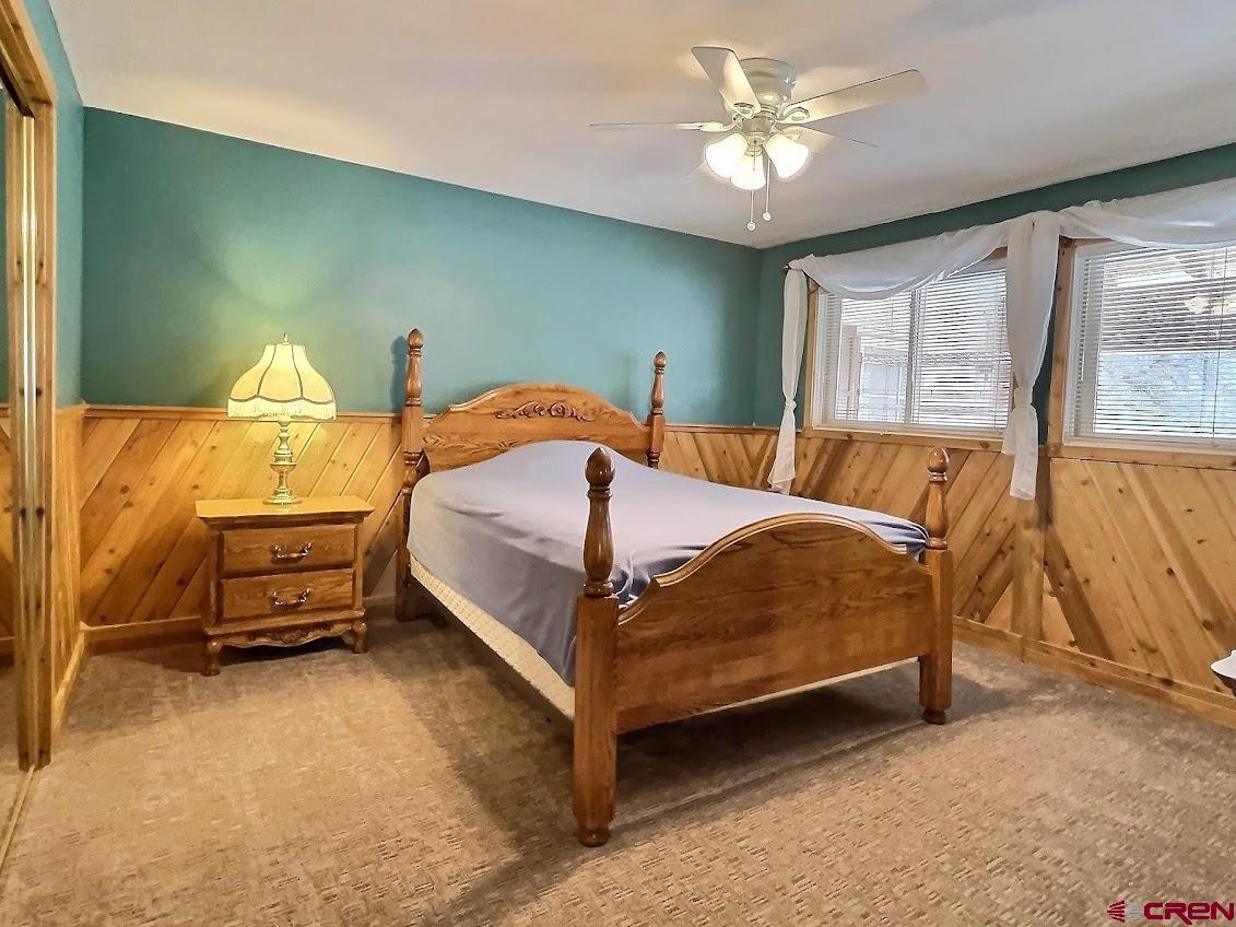 21007 Marion Road Eckert, CO 81418 - Photo 10 of 35 a bedroom with a bed and a chandelier