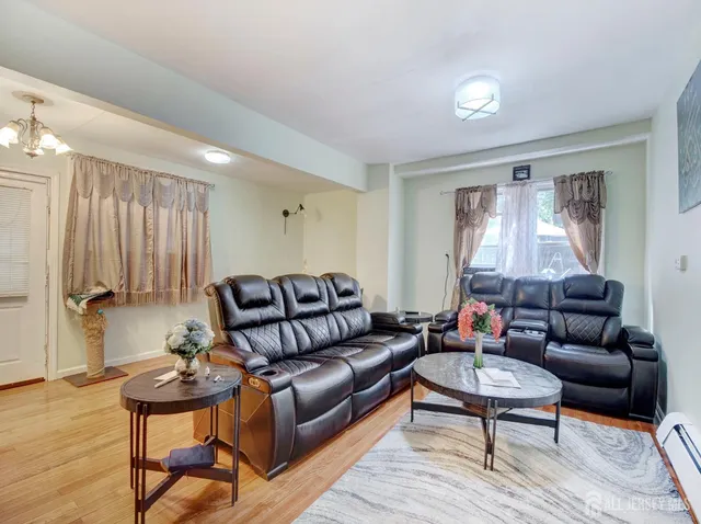 a living room with furniture a rug and a window