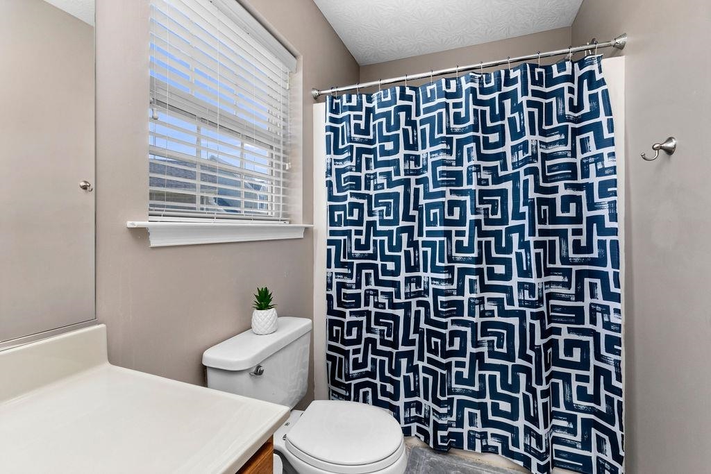 224 Inglecress Road Waynesboro, VA 22980 - Photo 27 of 42 a white toilet sitting next to a shower curtain
