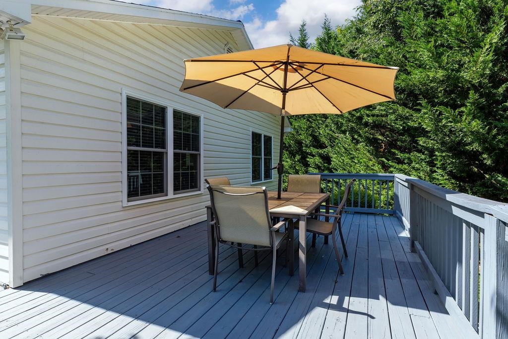 224 Inglecress Road Waynesboro, VA 22980 - Photo 39 of 42 a view of a roof deck with table and chairs under an umbrella