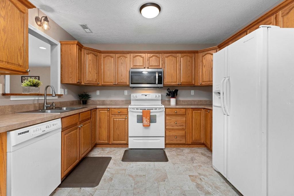 224 Inglecress Road Waynesboro, VA 22980 - Photo 7 of 42 a kitchen with stainless steel appliances granite countertop a stove a sink and a refrigerator