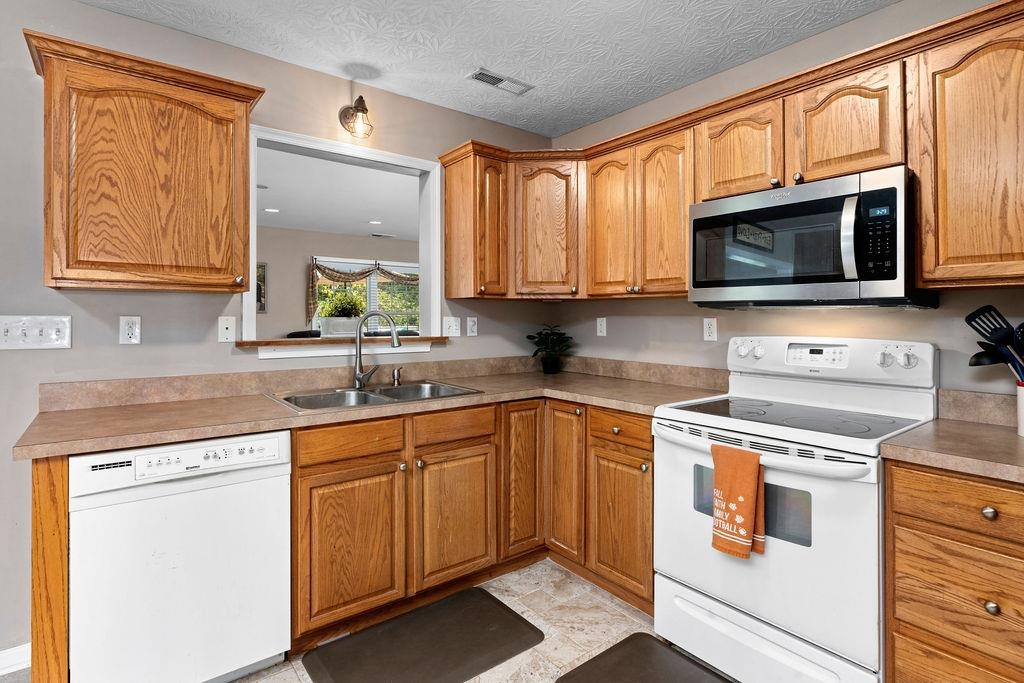 224 Inglecress Road Waynesboro, VA 22980 - Photo 9 of 42 a kitchen with stainless steel appliances granite countertop a stove sink microwave and cabinets