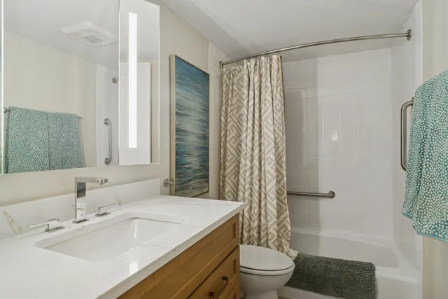 a bathroom with a sink toilet and shower