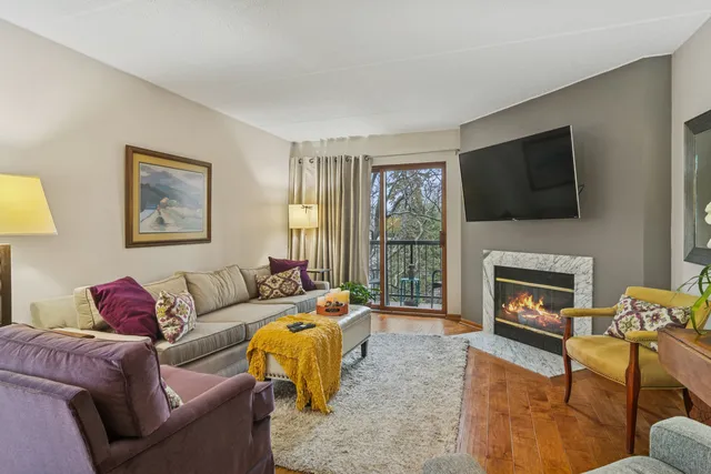 a living room with furniture a fireplace and a flat screen tv