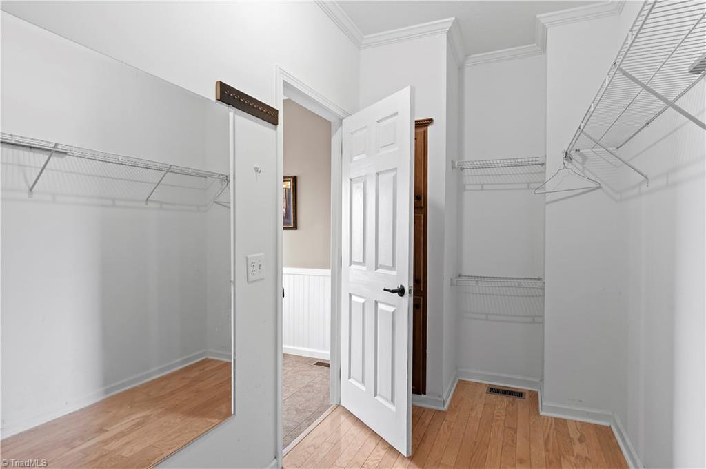 1607 Milling Road Mocksville, NC 27028 - Photo 19 of 38 One of the largest walk in closets I have ever seen with built-in shelves behind the door.