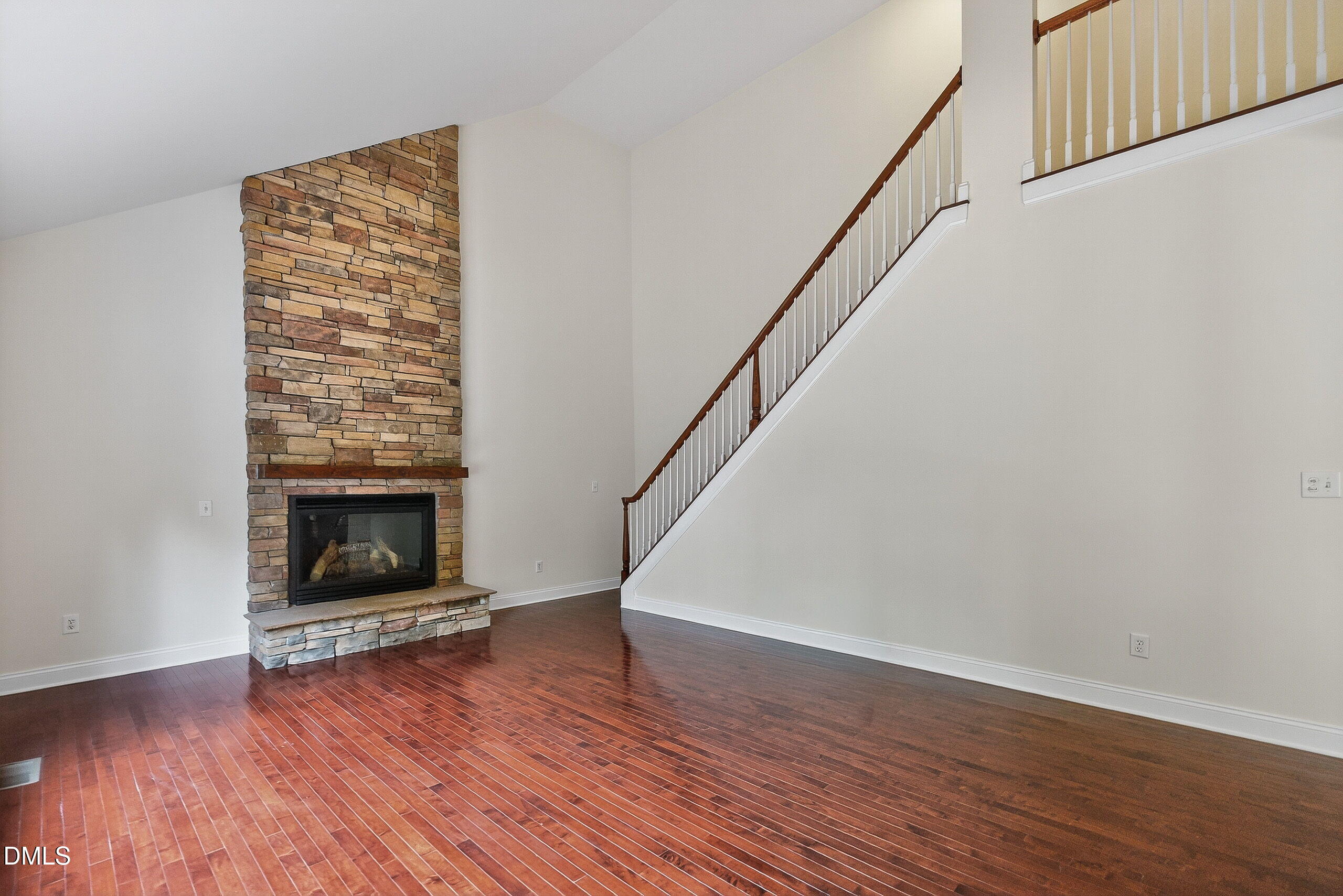 9441 Collingdale Way Raleigh, NC 27617 - Photo 13 of 54 a view of an empty room with wooden floor fireplace and a window