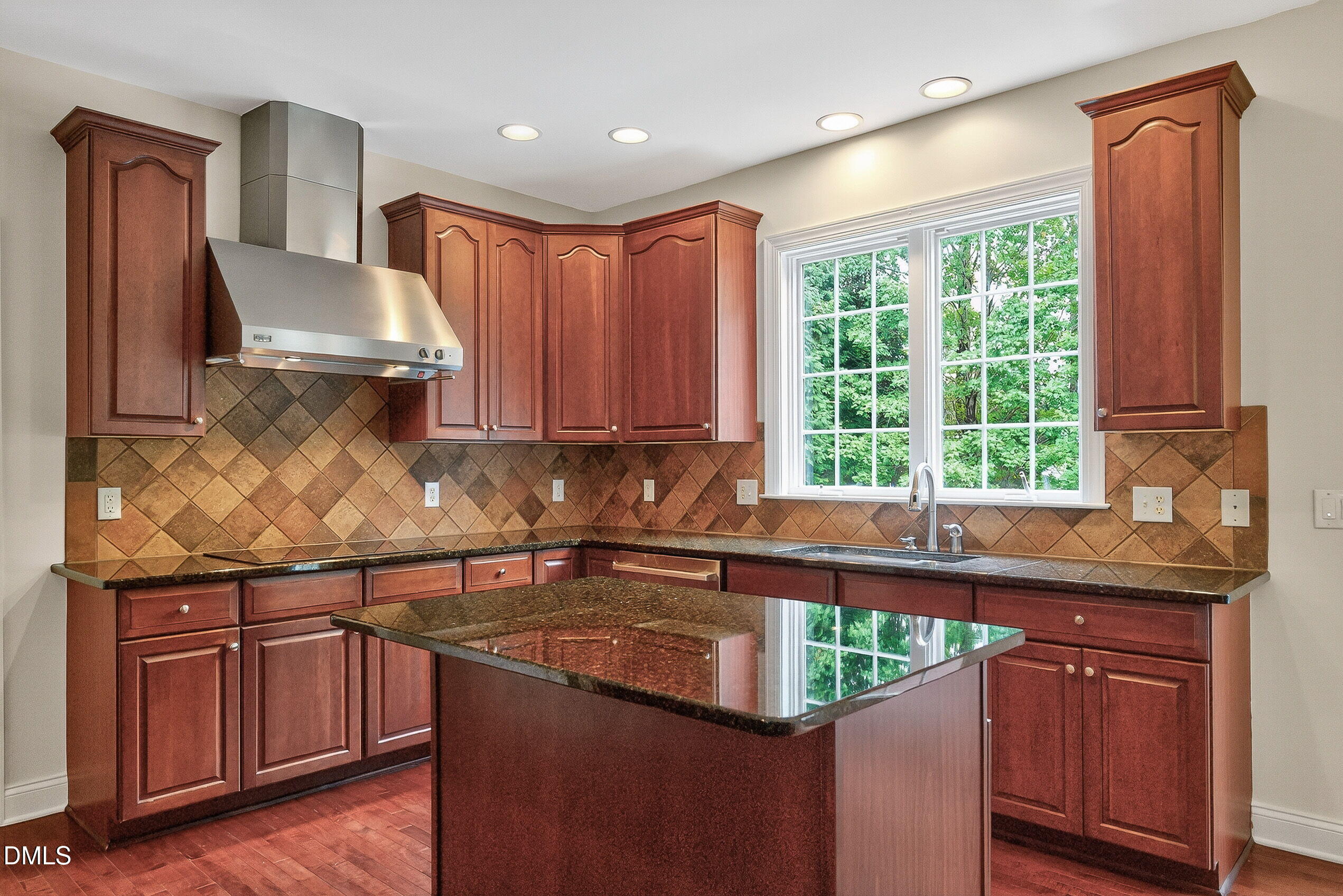 9441 Collingdale Way Raleigh, NC 27617 - Photo 16 of 54 a kitchen with stainless steel appliances granite countertop wooden cabinets a sink and a stove