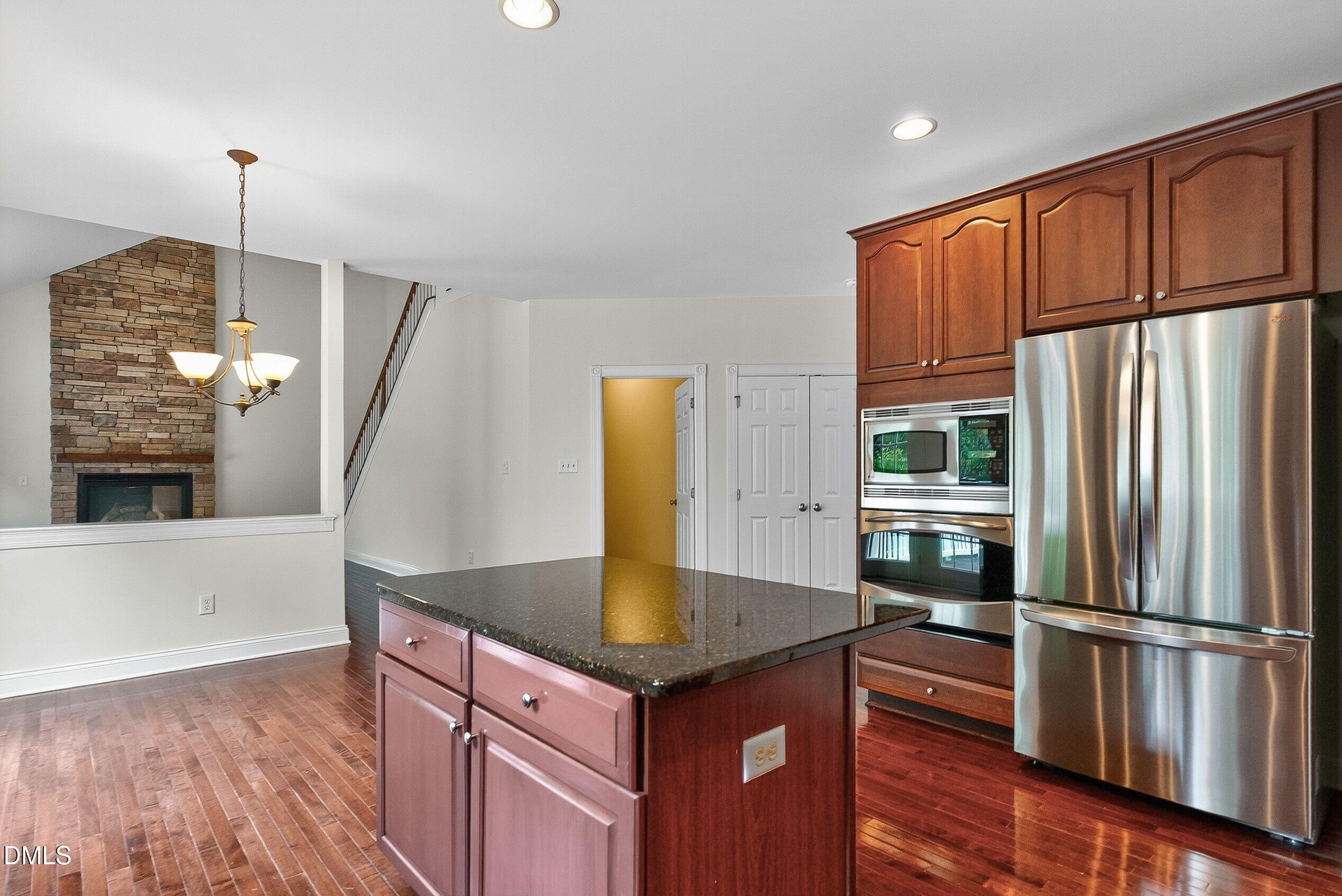 9441 Collingdale Way Raleigh, NC 27617 - Photo 20 of 54 a kitchen with stainless steel appliances granite countertop a refrigerator a stove and a wooden floors