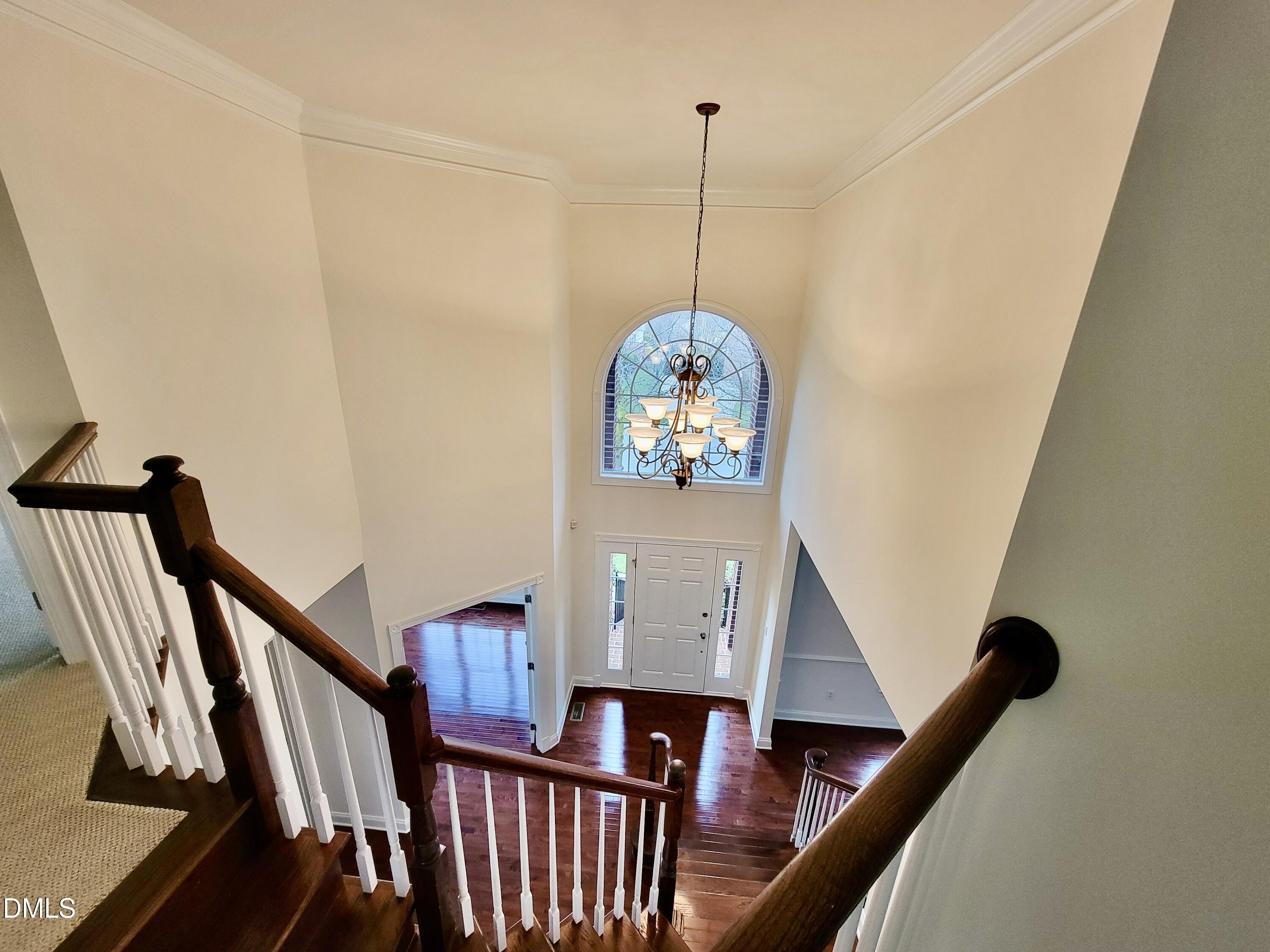 9441 Collingdale Way Raleigh, NC 27617 - Photo 23 of 54 a view of a hallway with wooden floor and staircase
