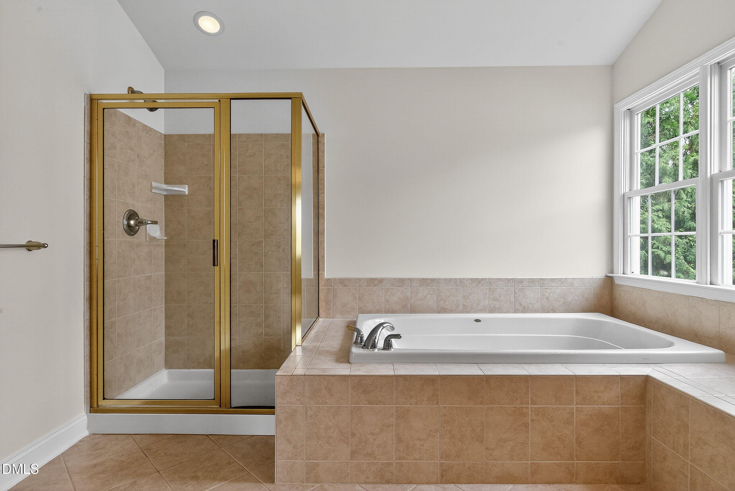 9441 Collingdale Way Raleigh, NC 27617 - Photo 29 of 54 a bathroom with a tub and a shower