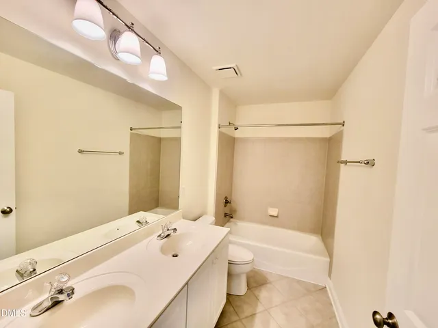 a front view of house with yard and trees in the background