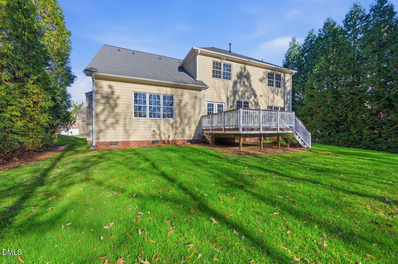 9441 Collingdale Way Raleigh, NC 27617 - Photo 38 of 54 a front view of house with yard and trees in the background