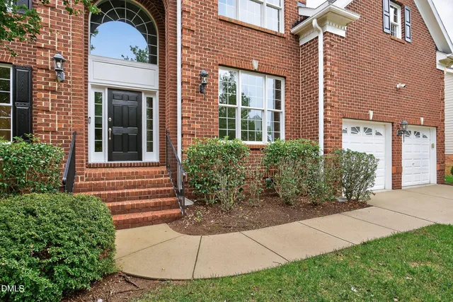 a view of an entryway with wooden floor a chandelier and a window