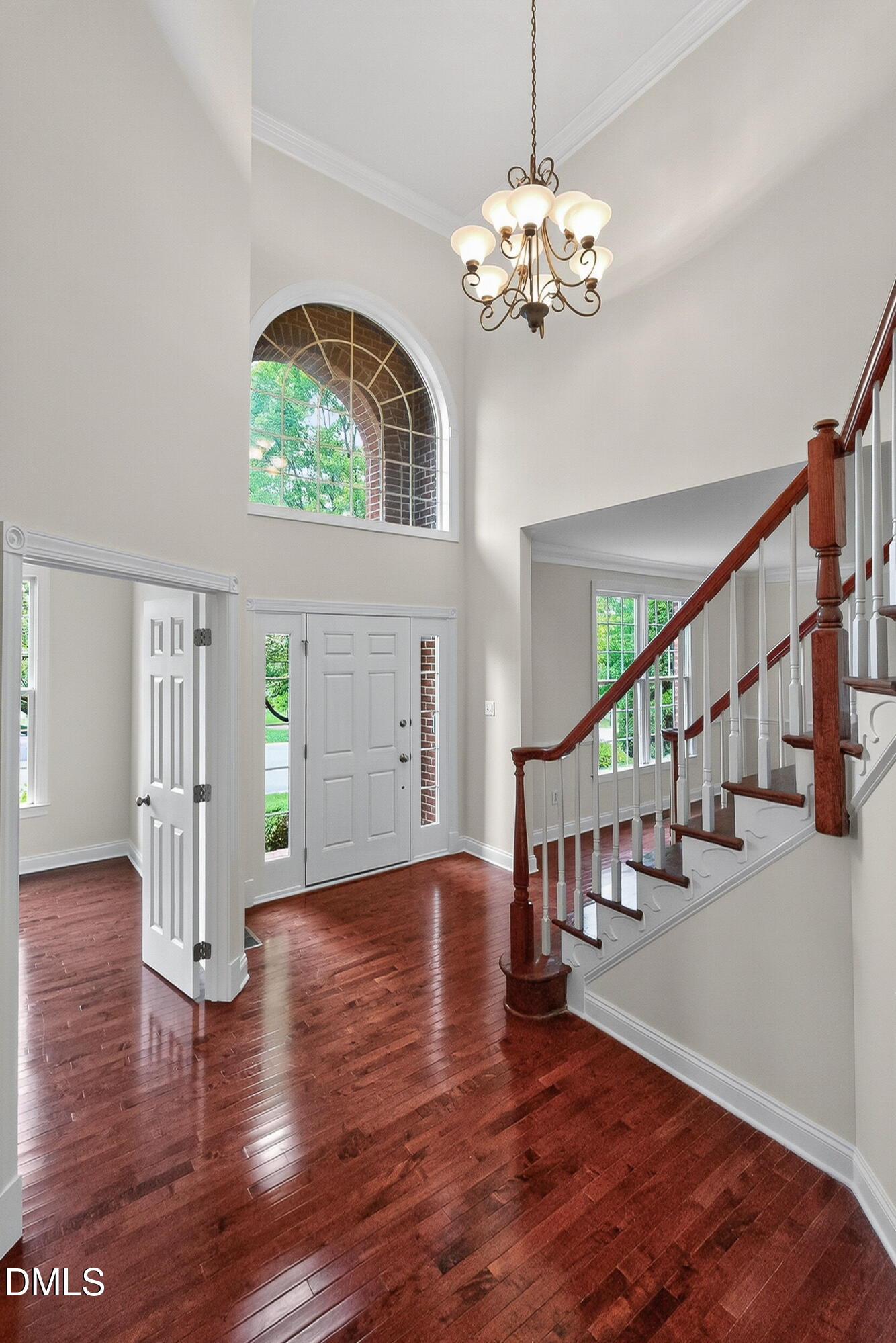 9441 Collingdale Way Raleigh, NC 27617 - Photo 5 of 54 a view of an entryway with wooden floor a chandelier and a window