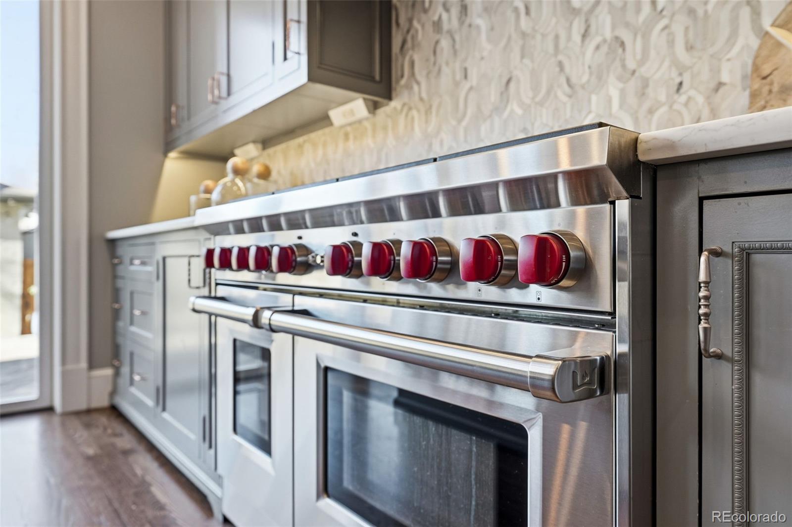 1257 Fillmore Street Denver, CO 80206 - Photo 19 of 50 a kitchen with stainless steel appliances granite countertop a stove and a sink