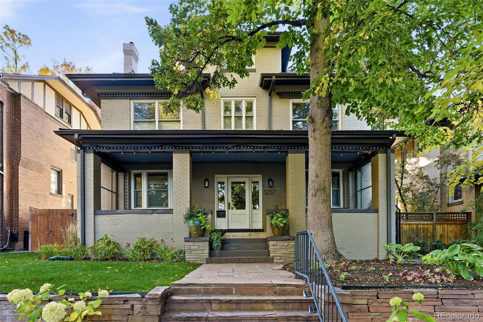 1257 Fillmore Street Denver, CO 80206 - Photo 2 of 50 a front view of a house with garden