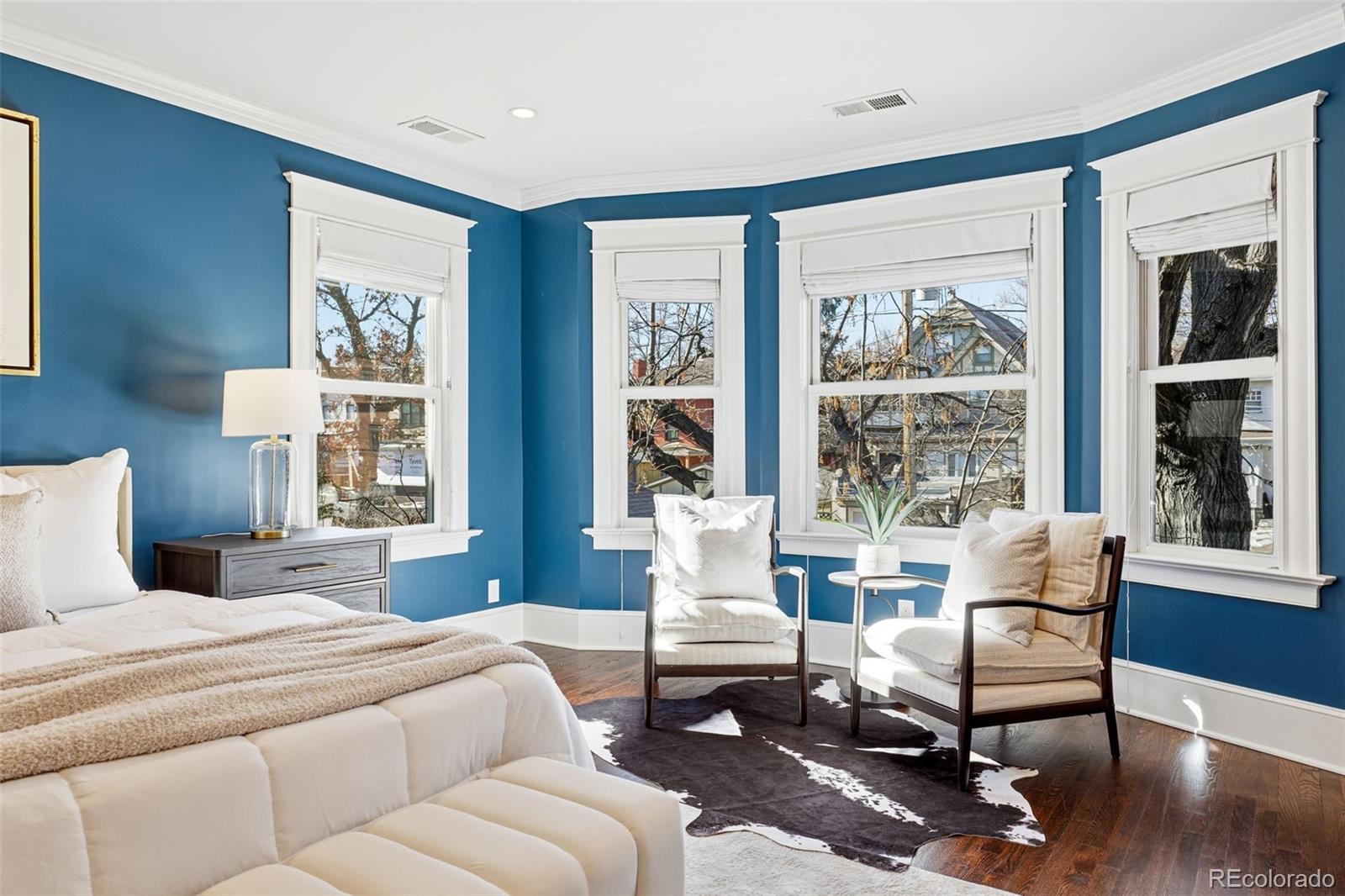 1257 Fillmore Street Denver, CO 80206 - Photo 27 of 50 a living room with furniture large windows and wooden floor