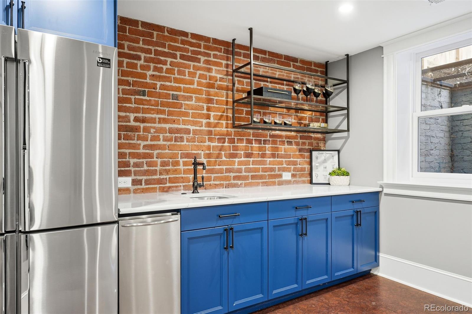 1257 Fillmore Street Denver, CO 80206 - Photo 43 of 50 a kitchen with stainless steel appliances a refrigerator and a window
