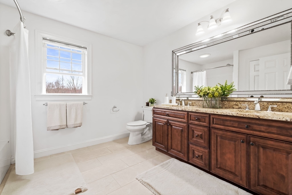 30 Neponset Street Walpole, MA 02071 - Photo 26 of 41 a spacious bathroom with a granite countertop sink a toilet and a mirror