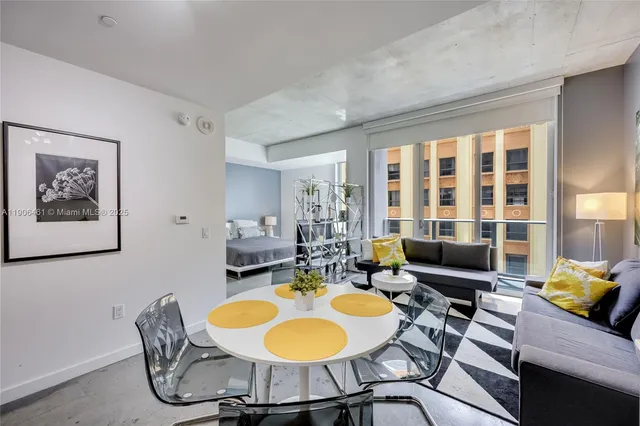a view of a dining room with furniture a rug and wooden floor
