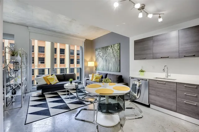 a living room with furniture a rug and a chandelier