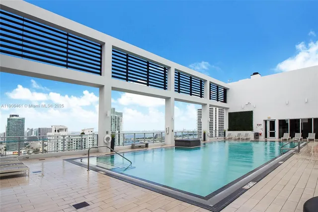 a view of swimming pool with outdoor seating