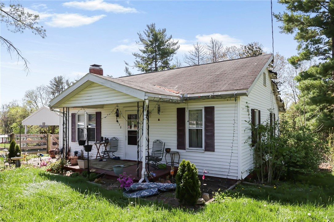 2390 Ridge Road Zanesville, OH 43701 - Photo 5 of 45 This charming home offers a cozy covered front porch, perfect for outdoor relaxation.