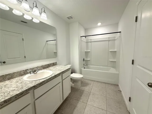 a view of a hallway with wooden floor and closet