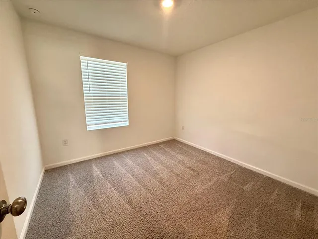 a bathroom with a granite countertop sink a toilet and bathtub