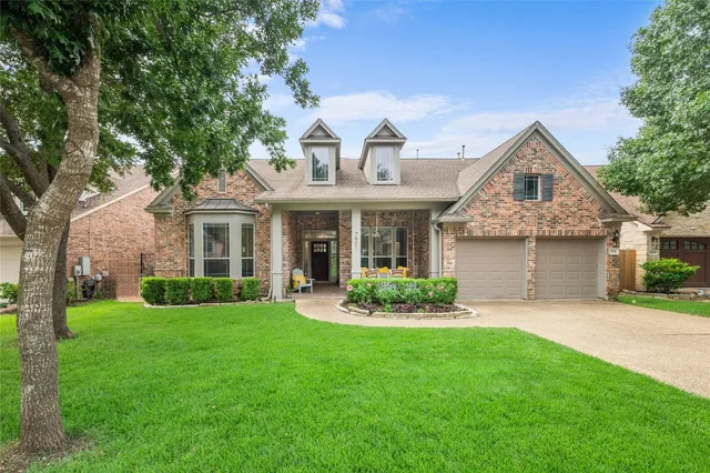 a front view of a house with a garden and plants