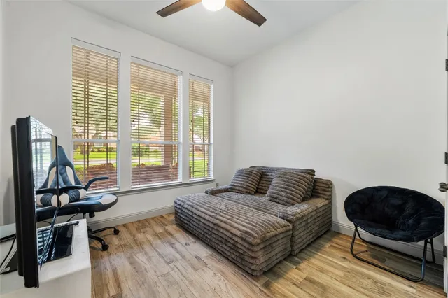 a bedroom with a bed and a flat tv screen on the dresser