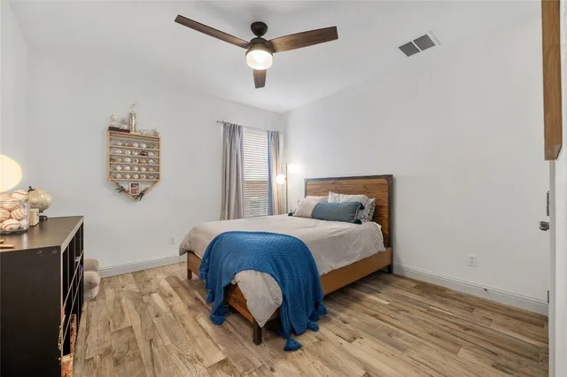 a bedroom with a bed and wooden floor