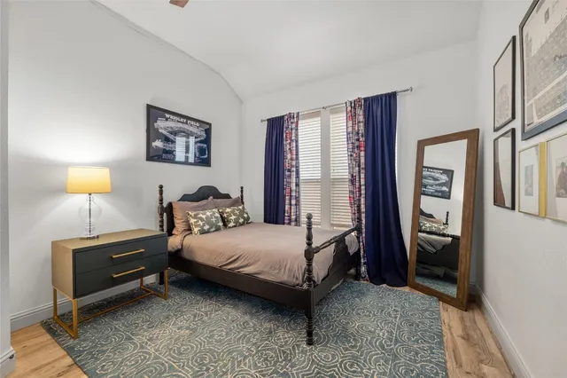 a bedroom with a bed and a lamp on table