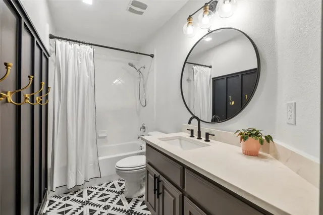 a bathroom with a sink a toilet and a mirror