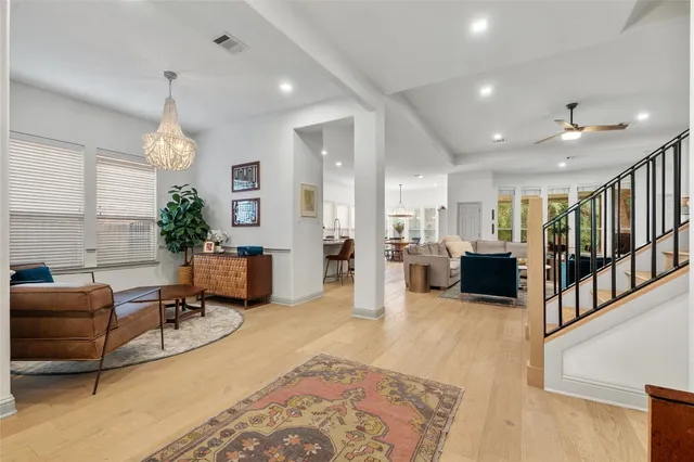 a living room with furniture windows and a chandelier
