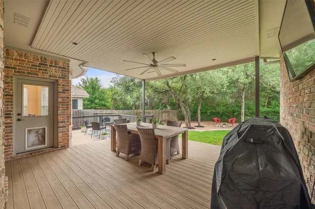 a view of a patio with table and chairs potted plants with wooden floor