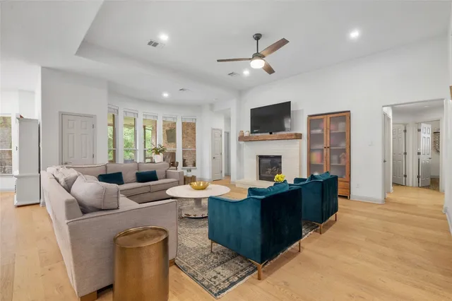 a living room with furniture a fireplace and a flat screen tv