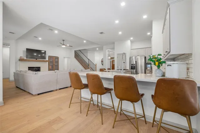 a living room with furniture and kitchen view